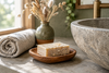 Oatmeal soap bar beside a stone sink with a linen hand towel